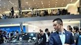 William Li, CEO of Nio Chinese multinational automobile manufacturer, stands next to Nio ET7 model electric car