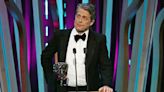 Hugh Grant Channels ‘Wonka’ Oompa Loompa Character While Presenting Best Director BAFTA Award: ‘Most of These Films Were Frankly...