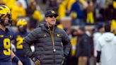 Michigan's Jim Harbaugh says he would take less salary if it meant college athletes would be paid