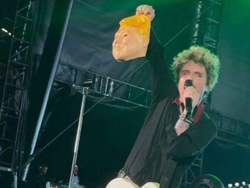 Green Day's Billie Joe Armstrong slammed for holding up Trump mask with ‘IDIOT’ scrawled after recent assassination bid (VIDEO)