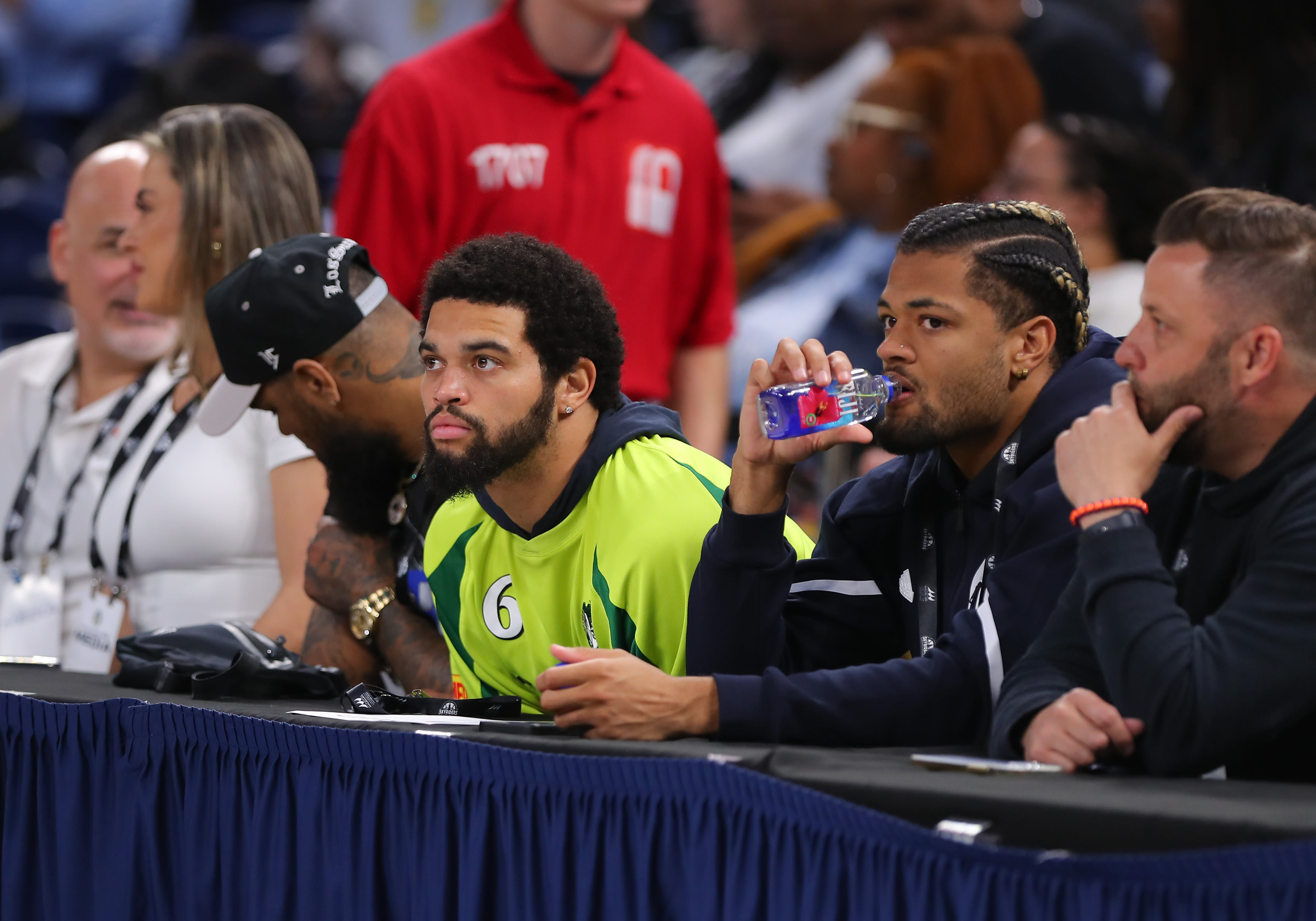 Caleb Williams, Keenan Allen, Rome Odunze front row at Chicago Sky preseason game