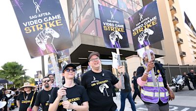 SAG-AFTRA Hits Picket Line At Warner Bros. Demanding “Baseline Of Respect” From Major Video Game Companies