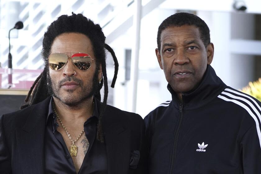 Lenny Kravitz answers video call from 'big brother' Denzel Washington onstage in Italy