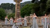 Despite weather glitch, the Paris Olympics flame is lit at the Greek cradle of ancient games