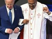 US President Joe Biden (L) stands with Bishop Ernest Morris Sr during a church service and campaign event at Mount Airy Church of God in Christ...