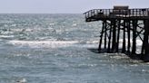 A piece of the battered Flagler Beach Pier breaks away and gets stuck nearby