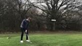 Golf swing fail in rainy park has ball land about ten feet in front of golfer