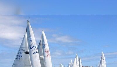 Olympic sailing ready to start with fast windsurfing, light winds, hot sun