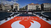 The Olympic torch is being welcomed in French port city of Marseille with fanfare and high security