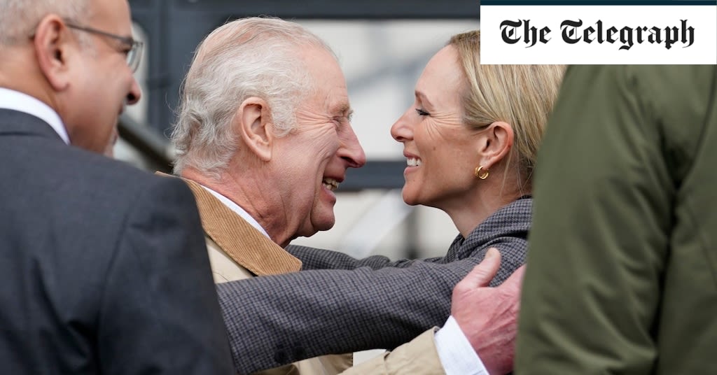 King embraced by Zara Tindall as he arrives at Windsor Horse Show