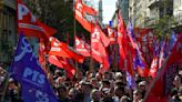 Argentina’s president announces economy deregulation as thousands protest against austerity