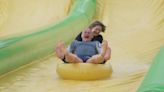 Lib Dem leader Sir Ed Davey tries out waterslide in latest election stunt