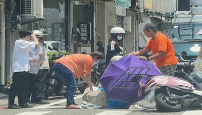 台灣好心人！ 短裙女車禍慘摔滾燙路面 路人撐傘蓋衣、水澆雙腿降溫