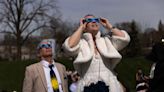 Hundreds of couples got married during the solar eclipse. Photos show mass weddings featuring moon-themed cakes and protective glasses.