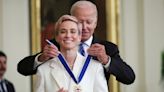 Megan Rapinoe smiles at fiancée Sue Bird as she takes photos of her at the Presidential Medal of Freedom ceremony