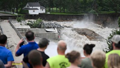Part of a Minnesota home has plunged into the Blue Earth River as deadly Midwest flooding threatens the nearby Rapidan Dam