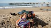 Christmas on the beach in Southern California, as rest of country copes with monster winter storm