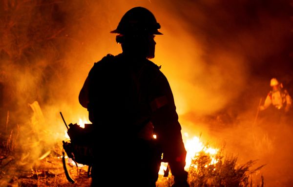 Photos show Bridge, Airport and Line wildfires raging in Southern California, torching dozens of homes and forcing thousands to evacuate