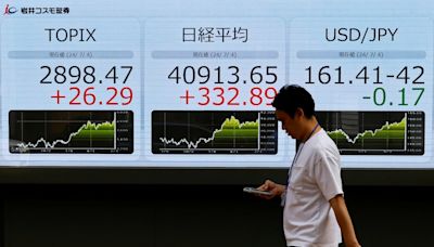 Japan’s main stock indexes at record closing highs as banks, autos and techs rise