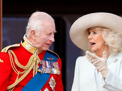 Queen Camilla's three-word exchange with King Charles after appearing to hurry him off the balcony at Trooping the Colour