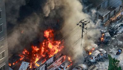 Scores killed and alert issued as Bangladesh anti-quota protesters set fire to state TV headquarters