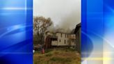 Smoke pours from roofline of Connellsville home