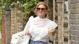 Isla Fisher looks typically chic in a sheer white blouse in Hampstead