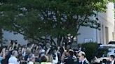 US Capitol police officers hold back media and protesters as former US president Donald Trump arrives for a meeting with US House Republicans on June 13, 2024