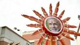 Supporters of Narendra Modi carry his portrait as they celebrate outside the BJP headquarters in New Delhi
