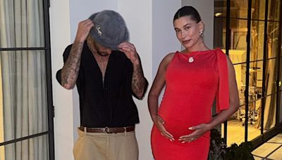 Pregnant Hailey Bieber Cradles Her Baby Bump in Ruby Red Frock With Justin Bieber