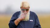 John Daly smokes a cigarette in neon tartan shorts at Royal Troon