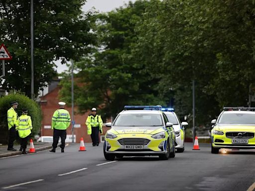 Road closed after unmarked GMP car involved in crash with officer rushed to hospital