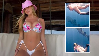 Watch incredible moment world's sexiest volleyball star swims with sharks