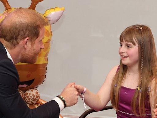 Prince Harry is given award by inspirational girl on solo UK visit