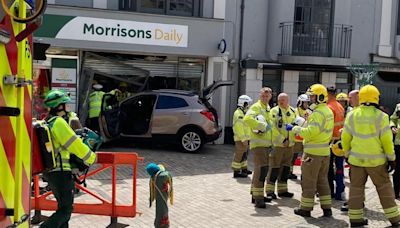 Four injured after car crashes into shop