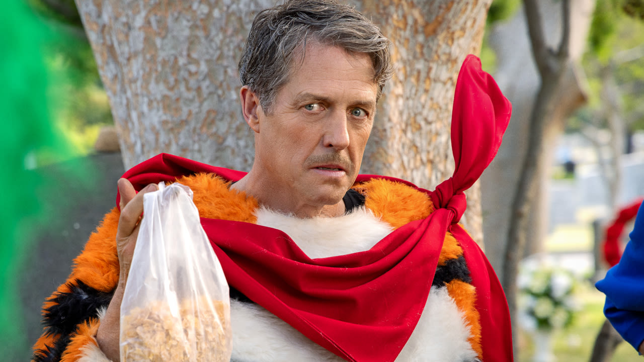 Unfrosted Marks The Third Time Hugh Grant's Played An Orange Character Recently, And He Had A Funny Answer When I...