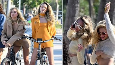 Supermodels Kate Upton and Candice Swanepoel put on leggy display and flash bra as they ride bikes