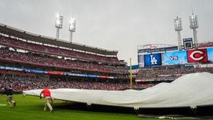 Reds ground crew member gets eaten by tarp during rain delay