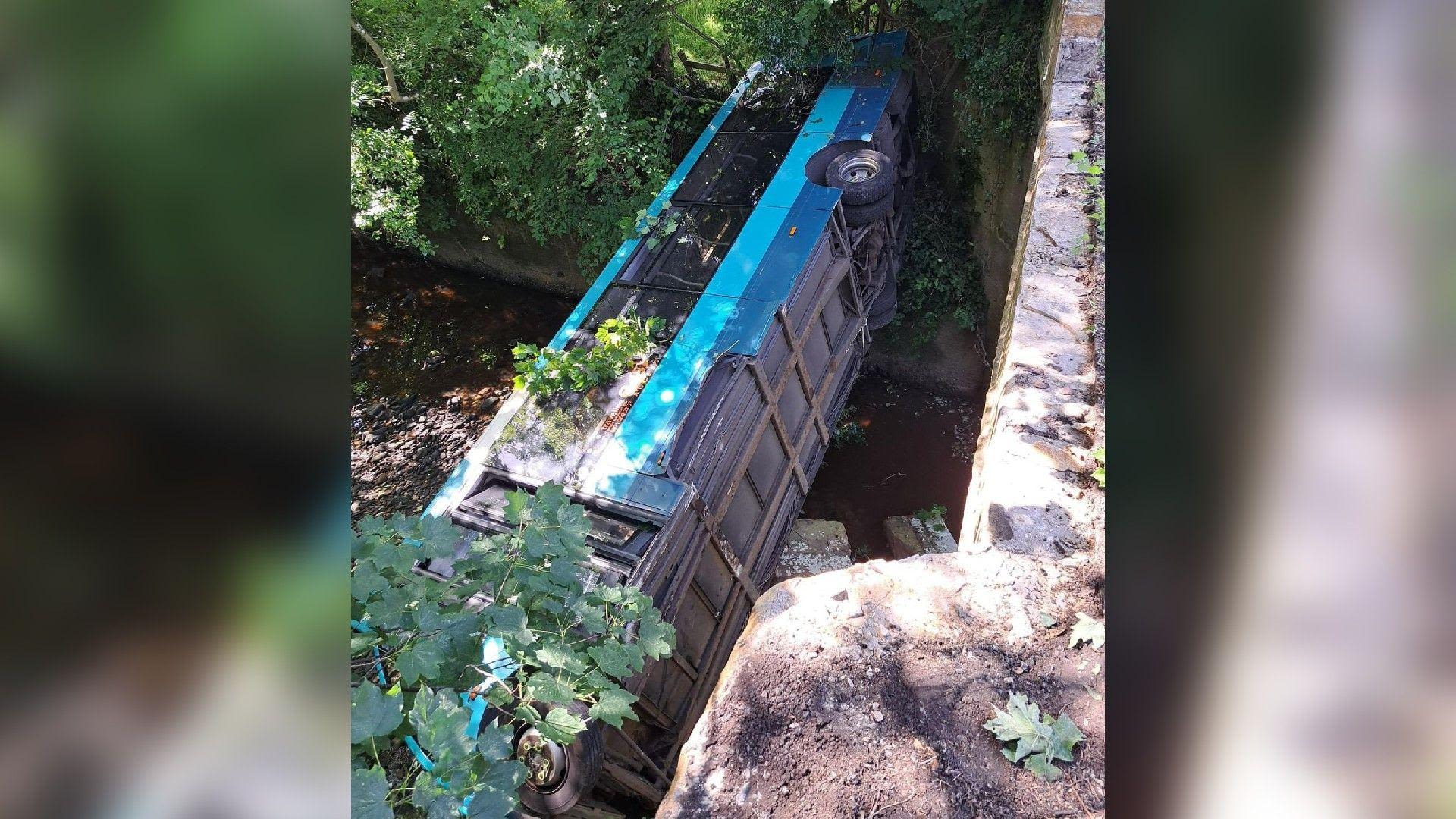 Bus removed from river after 30ft bridge fall