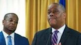Garry Conille (R) speaks after being installed as Haiti's Prime Minister in Port-au-Prince