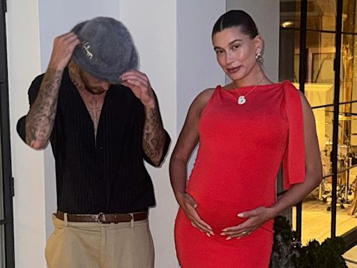 Pregnant Hailey Bieber Cradles Her Baby Bump in Ruby Red Frock With Justin Bieber