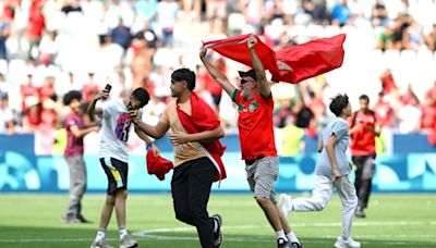 Olympic soccer gets off to violent and chaotic start as Morocco fans rush the field vs. Argentina