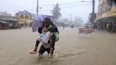 Bus passengers use rope to pull themselves to safety as floods hit Kenya's Mombasa