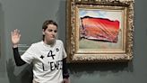 Climate protester sticks poster over Monet painting at the Musee D'Orsay