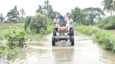 Police arrange pickets as flood water enters villages in Agency areas of Eluru district in Andhra Pradesh