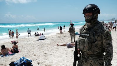 Gunmen open fire at rival drug dealers at a Cancun beach. A 12-year-old boy was left dead.