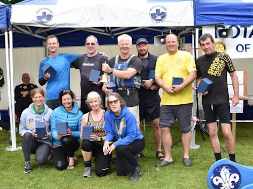 Teams paddle in the rain on The Mere for charity at popular boat regatta
