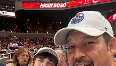 Father and son from Fort Simpson show off N.W.T. flag as Edmonton Oilers advance to final
