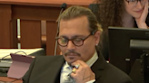 Johnny Depp laughs and covers face during heated cross-examination of psychiatrist testifying for Amber Heard