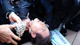 South Korea’s opposition leader stabbed in neck by man posing as autograph-hunter